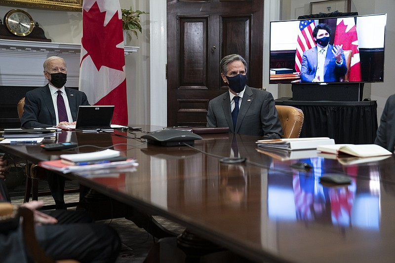 President Joe Biden and Secretary of State Antony Blinken listen as Canadian Prime Minister Justin Trudeau speaks during a virtual bilateral meeting, in the Roosevelt Room of the White House, Tuesday, Feb. 23, 2021, in Washington. (AP Photo/Evan Vucci)