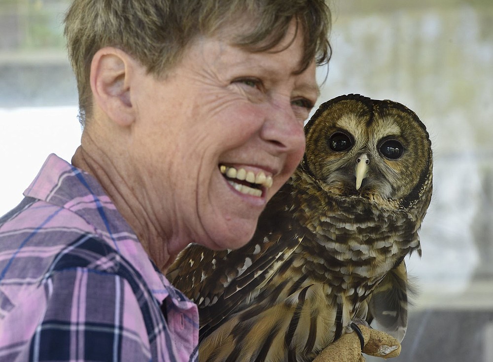 NWA Democrat-Gazette/CHARLIE KAIJO Lynn Sciumbato, operator of Morning Star Wildlife Rehabilitation Center, holds a barred owl during an annual Earth Day event, Saturday, April 27, 2019 at the Eagle Watch Nature Trail in Gentry. Local 4-H club members and other participants began by working in gardens that promote butterflies and other pollinators. The program included presentations on raptors and other wildlife by Lynn Sciumbato, operator of Morning Star Wildlife Rehabilitation Center, and moths, butterflies and other pollinators by University of Arkansas Professor Don Steinkraus.