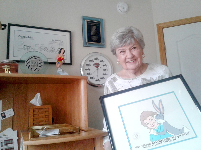 Photo submitted
Bella Vista resident Beverly Cannady stands with a series of mementos from her career in merchandise licensing.