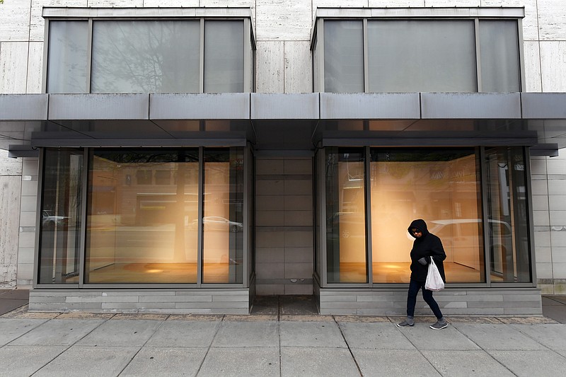 A pedestrian walks by empty window displays at a Neiman Marcus location in Washington, D.C. Big-name retailers have made headlines with bankruptcy filings, but other industries are seeing large increases as well. MUST CREDIT: Washington Post photo by Matt McClain