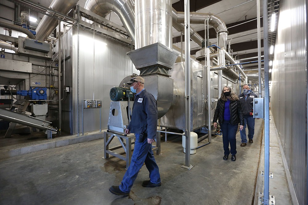 Jere Orvin (from left), operations supervisor at the Springdale Wastewater Treatment Facility, Jennifer Enos, facilities director, and Loren Sharp, operations manager, walk Thursday, February 25, 2021, through the biosolids huber dryer inside the Dryer Building at the facility on Silent Grove Road in Springdale. The biosolids huber dryer is the largest in North America. Check out nwadg.com/photos for a photo gallery.
(NWA Democrat-Gazette/David Gottschalk)