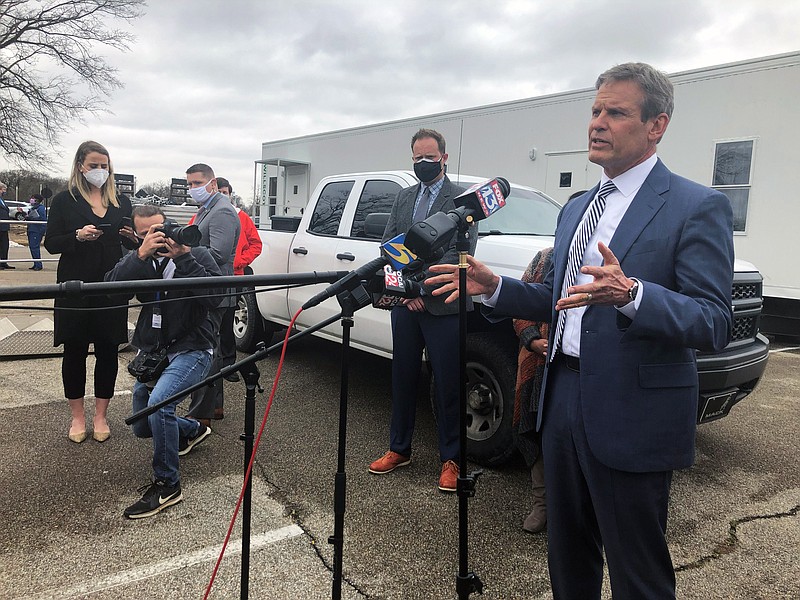 Tennessee Gov. Bill Lee, right, speaks with reporters about vaccine distribution problems in the state's most populous county on Friday, Feb. 26, 2021, in Memphis, Tenn. (AP Photo/Adrian Sainz)