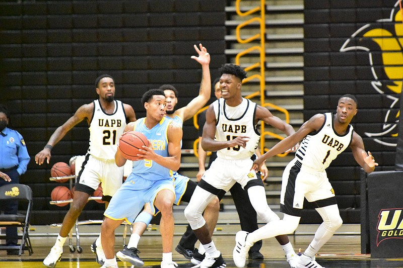 Jayden Saddler (5) of Southern University faces defensive pressure from Shaun Doss Jr. (21), Alvin Stredic Jr. (15) and Jalen Lynn (1) of the University of Arkansas at Pine Bluff during the second half on Saturday at H.O. Clemmons Arena. (Pine Bluff Commercial/I.C. Murrell)