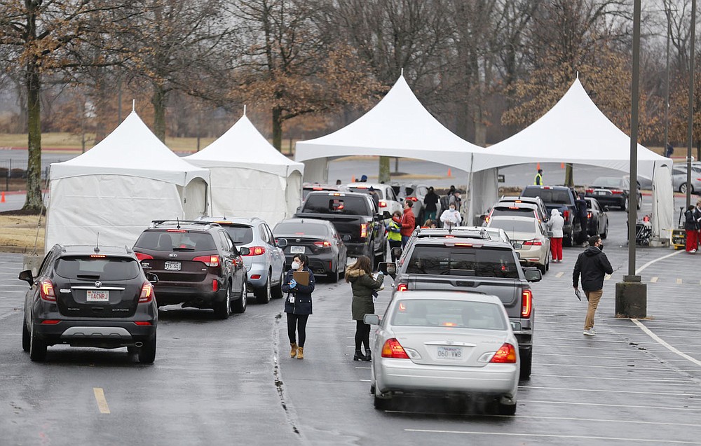 A queue begins to form Friday, February 26, 2021, during a drive thru mass vaccination clinic hosted by the Northwest Arkansas Council at J.B. Hunt Transport Corporate Headquarters in Lowell. Multiple area health providers participated in the event that planned on administering 3,000 doses of the Moderna vaccine to those with confirmed appointments. Check out nwaonline.com/210227Daily/ and nwadg.com/photos for a photo gallery.
(NWA Democrat-Gazette/David Gottschalk)