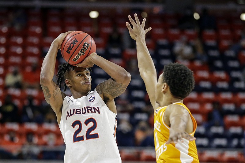 Auburn guard Allen Flanigan (22) puts up a three pointer as Tennessee guard Jaden Springer (11) defends during the first half of an NCAA basketball game Saturday, Feb. 27, 2021, in Auburn, Ala. (AP Photo/Butch Dill)