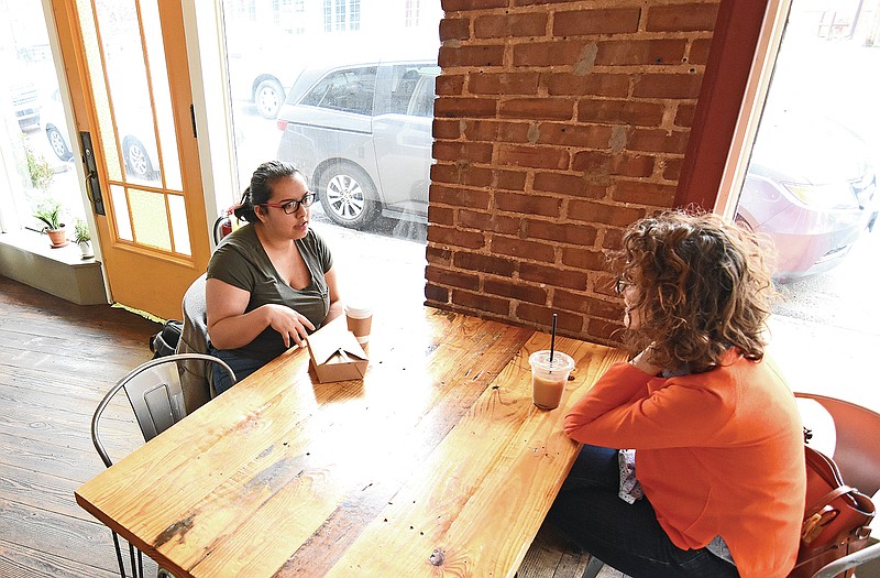 Laura Cruse (right), a mentor for Immerse Arkansas, and her mentee, Lyndsey Longinotti, talk Saturday, Feb. 27, 2021 at Mylo’s Coffee in Little Rock.
(Arkansas Democrat-Gazette/Staci Vandagriff)