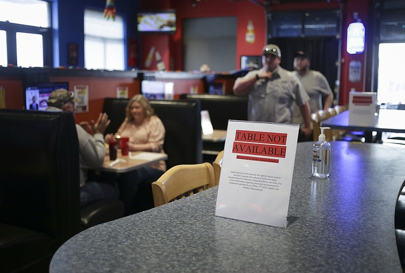 A social distancing sign is posted, Saturday, February 27, 2021 at Jose's Bar and Grill in Tontitown. Local governments report sales tax revenues continue to grow despite the covid-19 pandemic, but Doug and Pauline Allen, owners of Jose's Bar and Grill, say their business and others like it, haven't done well. Check out nwaonline.com/210228Daily/ for today's photo gallery. 
(NWA Democrat-Gazette/Charlie Kaijo)