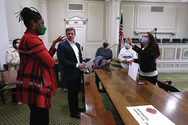 Rep. Denise Ennett (left), D-Little Rock, and Rep. Jimmy Gazaway (left center), R-Paragould, talk with Barbara Raney (center), Donna Drury (right center) and Loriee Evans (right) after an announcement by Gazaway introducing a proposal for a bill on protecting renters on Friday, Feb. 26, 2021, at the state Capitol in Little Rock. 
(Arkansas Democrat-Gazette/Thomas Metthe)