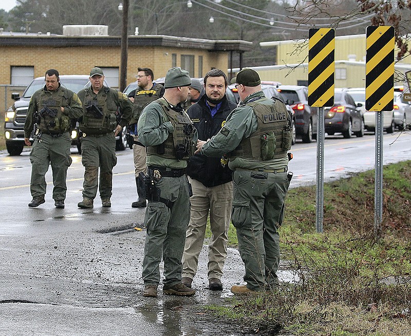 Law enforcement personnel talk Monday March 1, 2021 at Watson Chapel Junior High School as they investigate a shooting at the school. More photos at arkansasonline.com/32school/.  (Arkansas Democrat-Gazette/Staton Breidenthal)