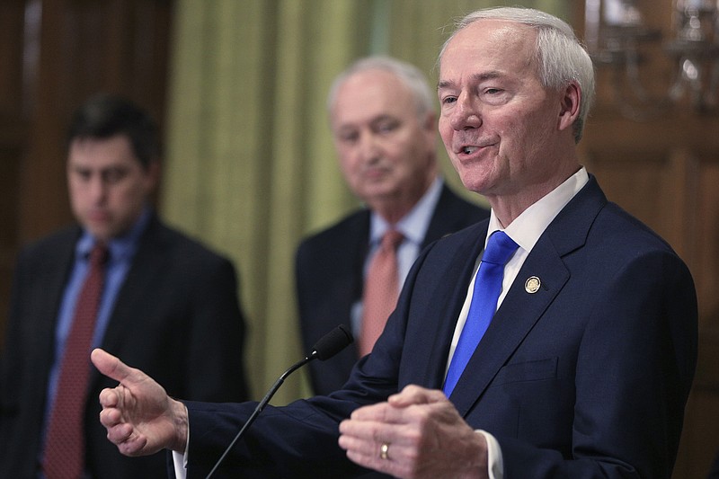 FILE - In this March 23, 2020 file photo, Gov. Asa Hutchinson, right, speaks in Little Rock, Ark. Hutchinson said Sunday, Feb. 21, 2021, he will not back former President Donald Trump if he runs for the White House in 2024, saying “it’s time” to move on to different voices in the Republican Party.  (Staton Breidenthal/The Arkansas Democrat-Gazette via AP, File)