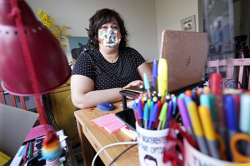 Jennifer Simon, an elementary school speech language pathologist, sits at her desk in her home Feb. 25, 2021, in Nashville, Tenn. Simon and a fellow teacher took a sick day from their schools and made a four-hour round trip to rural Van Buren County in Tennessee to get their COVID-19 vaccination. (AP Photo/Mark Humphrey)