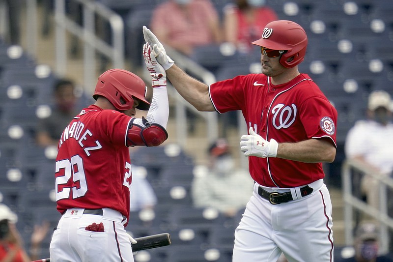 Washington Nationals' Ryan Zimmerman, right, is congratulated by teammate Yadiel Hernandez after hitting a solo home run during the third inning of Monday's spring training game against the Houston Astros in West Palm Beach, Fla. - Photo by Jeff Roberson of The Associated Press