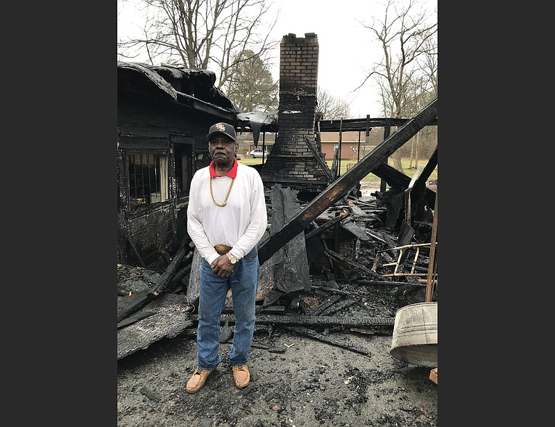 James Harold Jones, aka “Mr. Harold,” stands in the fire-damaged pit area of his Jones Bar-B-Q Diner in Marianna on Sunday. Locals and fans from across the country are contributing to the rebuilding of the award-winning establishment. (Special to the Democrat-Gazette/Steve Higginbothom)