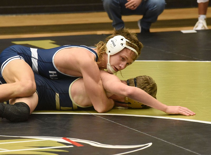 Lane Parrish (left) competes Saturday Jan. 23 2021 in the 6A West Conference wrestling meet at Bentonville High School. Parrish will compete in the Class 6A state wrestling tournament starting today at the University of Arkansas-Little Rock.
(NWA Democrat-Gazette/Flip Putthoff)