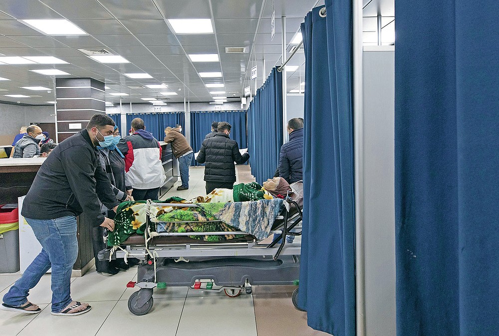 A Palestinian patient infected with COVID-19 is admitted for medical observation at the emergency unit, in the Palestine Medical Complex, in the West Bank city of Ramallah, Tuesday, March 2, 2021. (AP Photo/Nasser Nasser)
