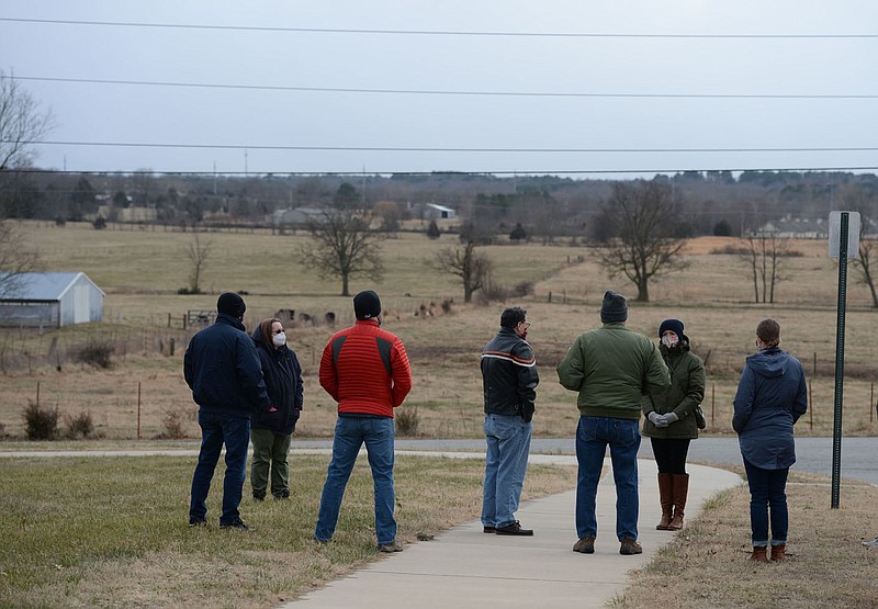 Architect Alli Quinlan (second from right) leads a tour Jan. 15, 2021, of land considered for annexation and rezoning for Fayetteville city staff and City Council members east of Crossover Road and the Botanical Garden of the Ozarks in Fayetteville. The City Council accepted the land for annexation Tuesday but held off on an associated plan for development for the site. (File photo/NWA Democrat-Gazette/Andy Shupe)