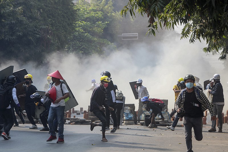 Anti-coup protesters run from teargas and charging riot police and soldiers in Mandalay, Myanmar, Wednesday, March 3, 2021. Demonstrators in Myanmar took to the streets again on Wednesday to protest last month's seizure of power by the military. (AP Photo)