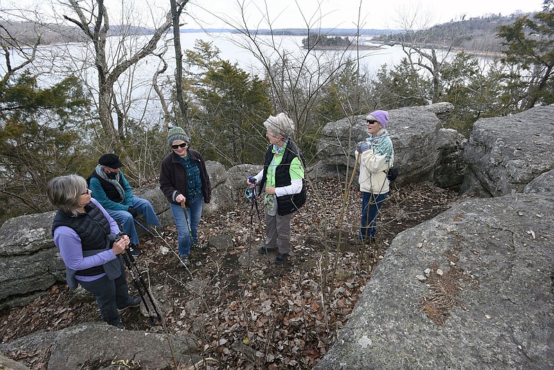 Rim Rock Trail at Prairie Creek park includes views of Beaver Lake during a 1-mile hike. Linda Heter (from left), Sheila Ross, Carol Graham, Cathy Ross and Peggy Bulla pause Jan. 29 2021 at a vantage point along the trail.
(NWA Democrat-Gazette/Flip Putthoff)