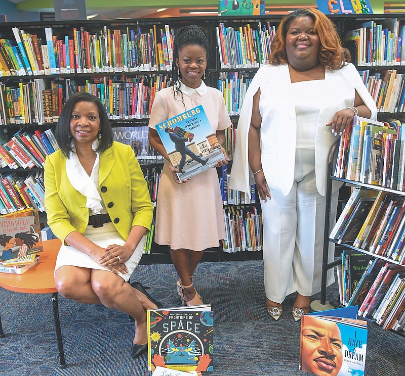 Dionne Jackson, Kanesha Adams, and Sherra Bennett have their photo taken at the Garland County Library. - Photo by Grace Brown of The Sentinel-Record