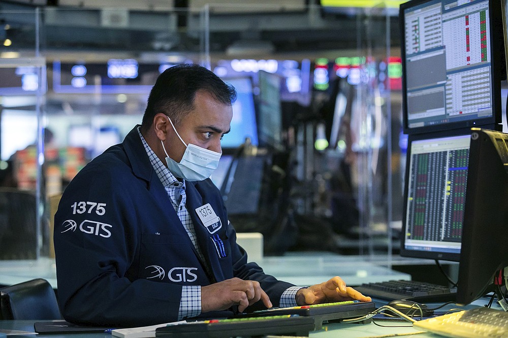 In this photo provided by the New York Stock Exchange, specialist Dilip Patel works on the floor, Wednesday, March 3, 2021, in New York. Stocks were mostly lower in afternoon trading as another tick up in bond yields gave investors pause. (Courtney Crow/New York Stock Exchange via AP)
