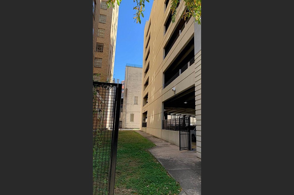 The Downtown Little Rock Partnership plans to put a pocket park, inclulding a “gallery wall” collection of murals, in the narrow stretch of grassy land off the 700 block of Main Street between the Donaghey Building and the next-door parking deck. (Special to the Democrat-Gazette)