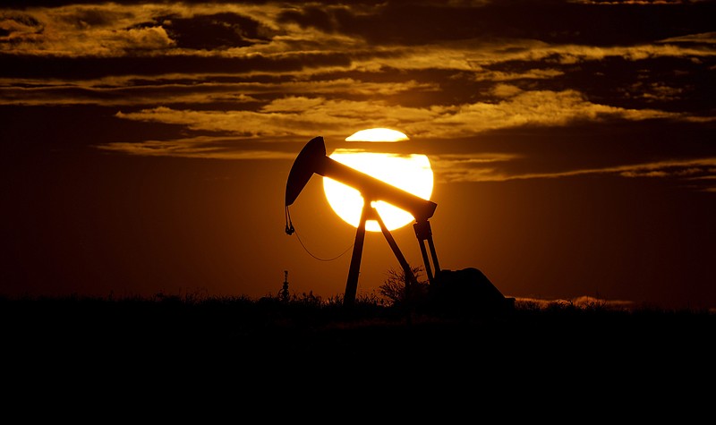FILE - In this Wednesday, April 8, 2020, file photo, the sun sets behind an idle pump jack near Karnes City, USA.  Members of oil producer cartel OPEC and allied countries are meeting online Thursday March 4, 2021,  considering a possible increase in production now that prices have recovered to near their pre-pandemic levels.  (AP Photo/Eric Gay, File)