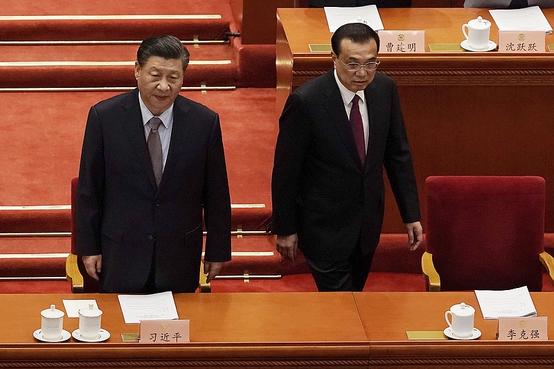 Chinese President Xi Jinping, left, and Premier Li Keqiang arrive for the opening session of Chinese People's Political Consultative Conference (CPPCC) at the Great Hall of the People in Beijing, Thursday, March 4, 2021. (AP Photo/Andy Wong)