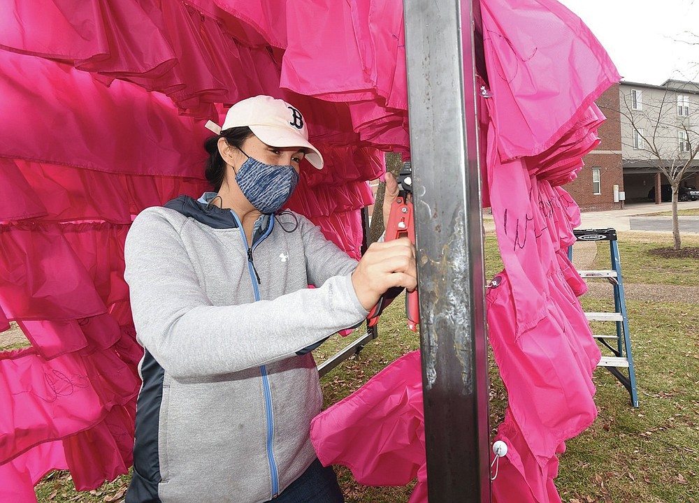 TRAIN STATION ART
Danielle Hatch attaches fabric Saturday Feb. 27 2021 to her sculpture "Guide These, My Hands" at Train Station Park on Main Street in Bentonville. Hatch created the sculpture and Traci Manos wrote a poem that's part of the art and helped with the embroidery on 360 yards of fabric that is placed over a metal frame. Hatch started building the piece in January. Go to nwaonline.com/210228Daily/ to see more photos.
(NWA Democrat-Gazette/Flip Putthoff)