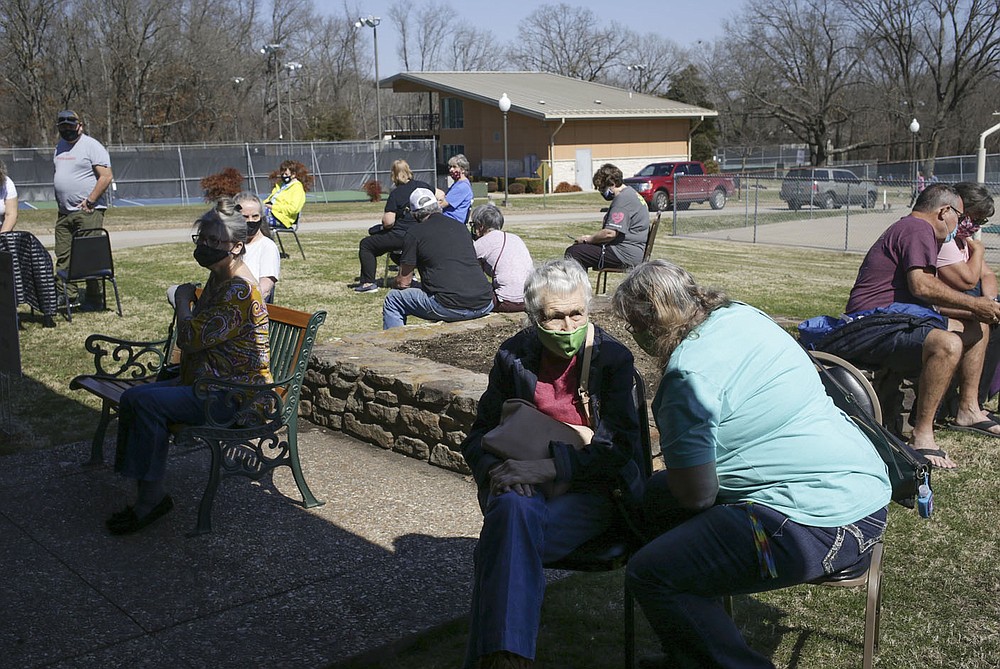 People wait outside after receiving their covid-19 vaccines, Thursday, March 4, 2021 at Riordan Hall in Bella Vista. Vaccine recipients wait 15 minutes at the administration site after receiving their vaccines in the event of an adverse reaction. The Bella Vista Fire Department with the help of volunteers held a vaccine clinic for people in Phase 1-B. They planned 1,200 first doses for the one-day event. Check out nwaonline.com/210305Daily/ for today's photo gallery.
(NWA Democrat-Gazette/Charlie Kaijo)