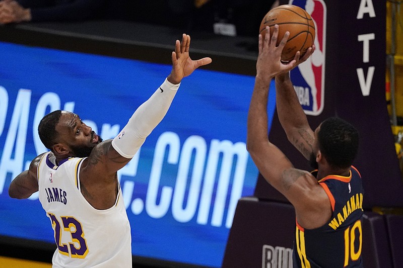 Golden State Warriors guard Brad Wanamaker, right, shoots as Los Angeles Lakers forward LeBron James defends Sunday during the first half of an NBA game in Los Angeles. - Photo by Mark J. Terrill of The Associated Press