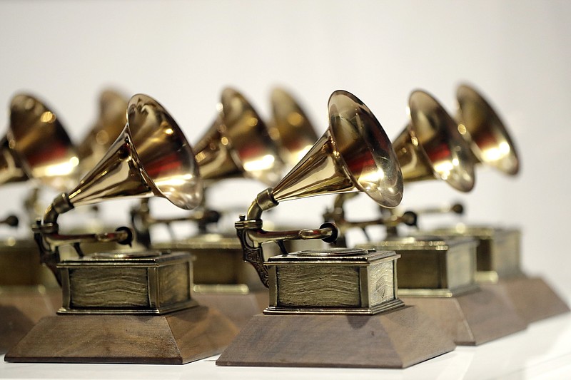 FILE - In this Oct. 10, 2017, file photo, various Grammy Awards are displayed at the Grammy Museum Experience at Prudential Center in Newark, N.J. The Recording Academy is partnering with Berklee College of Music and Arizona State University to complete a study focused on women's representation in the music industry.. The academy, which puts on the annual Grammy Awards, said the lack of female creators in music is “one of the most urgent issues in the industry today." (AP Photo/Julio Cortez, File)