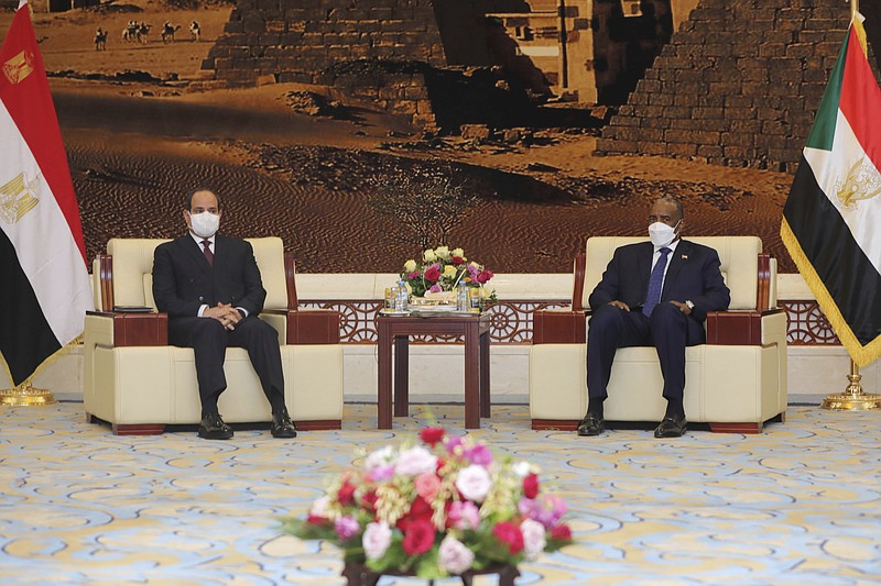 Egyptian President Abdel Fattah al-Sisi meets Chairman of the Sovereignty Council of Sudan Gen. Abdel Fattah Abdelrahman al-Burhan at the Presidential Palace in Khartoum, Sudan, Saturday, March. 6, 2021.  Egypt's presidency says President Abdel Fattah el-Sissi trip was to address an array of issues, including economic and military ties and the two nations’ dispute with Ethiopia over a massive dam Addis Ababa is building on the Blue Nile. The visit comes amid a rapprochement between the two governments. (Presidency of Sudan via AP)