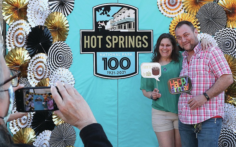 An unidentified woman, left, takes Karen Strawbridge and Mike Rozak‚Äôs photo at a picture booth during the park‚Äôs 100th anniversary event Thursday, March 4, 2021. The couple who were recently engaged are viditing from Copley Ohio. Photo by Richard Rasmussen of The Sentinel-Record