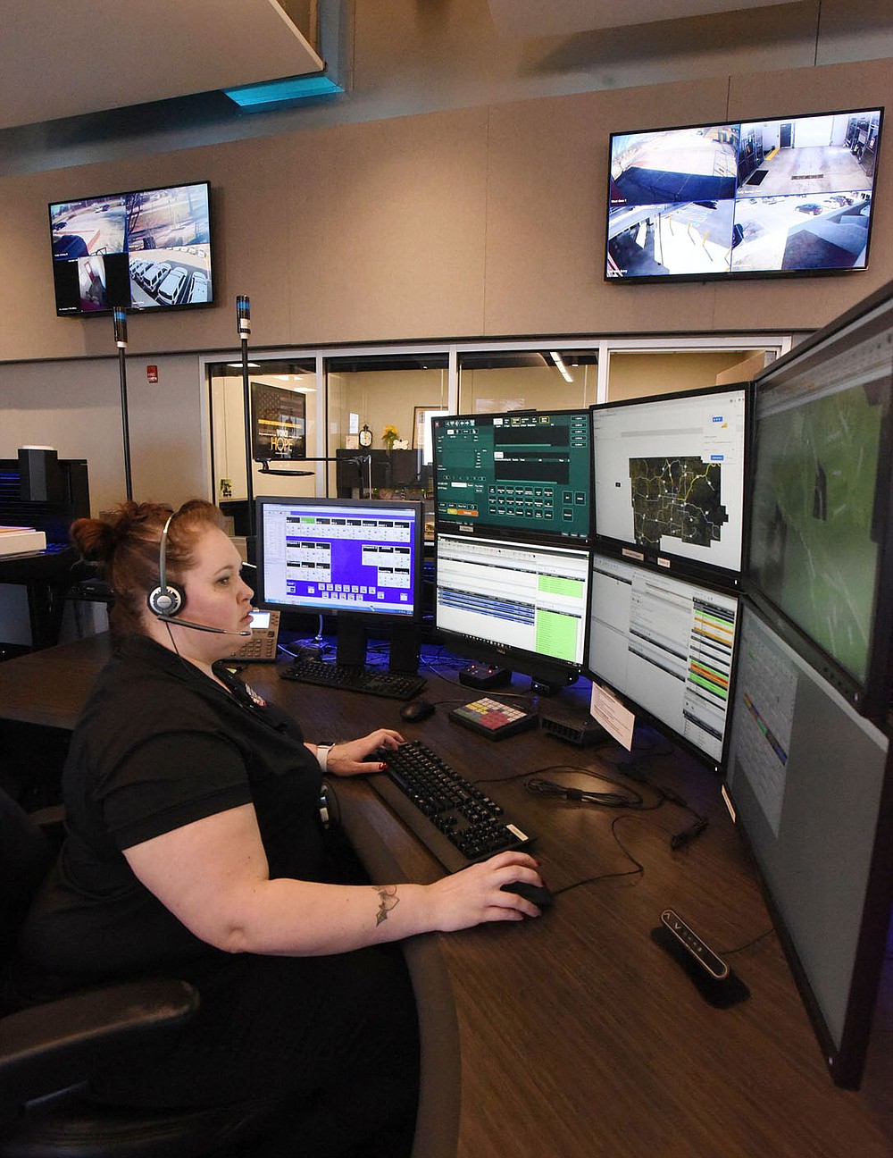 Desiree Beaver looks at information while on duty Tuesday March 2 2021 in the communications center at the Bentonville Police Department. A new radio system for the department is part of a $266 million bond issue residents will vote on on April 13.
(NWA Democrat-Gazette/Flip Putthoff)
