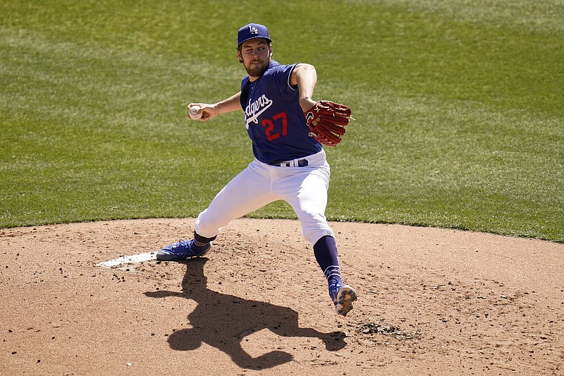 Pitching with one eye closed, Los Angeles Dodgers starting pitcher Trevor Bauer throws a pitch against the San Diego Padres during the second inning of Saturday's spring training game in Phoenix. - Photo by Ross D. Franklin of The Associated Press