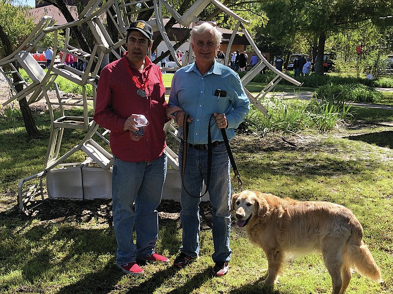 Jonesboro Human Development Center resident Danny with dad Terry Johnson and dog Fred. Families of the centers' clients are anxious for off-campus visits to resume. (Special to the Arkansas Democrat-Gazette)