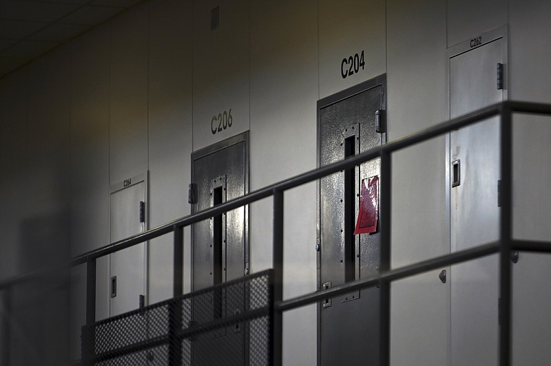 FILE - In this Monday, Jan. 4, 2021, file photo, a red tag hangs on a cell door, signifying an active COVID-19 case for its inhabitants at Faribault Prison, in Faribault, Minn. A Tennessee advisory panel tasked with determining eligibility for the COVID-19 vaccine acknowledged that prison inmates in the state were high risk, but concluded that prioritizing them for inoculation could be a “public relations nightmare.” (Aaron Lavinsky/Star Tribune via AP, File)