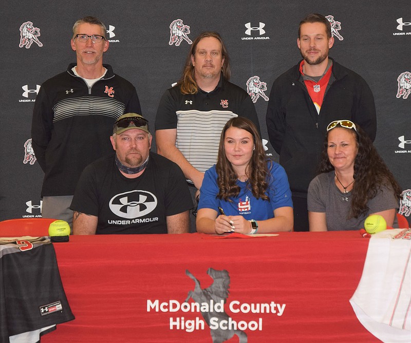 RICK PECK/SPECIAL TO MCDONALD COUNTY PRESS Alexa Hopkins (bottom row, center) recently signed a letter of intent to play softball at Murray State College in Tishomingo, Okla. Front row, left to right are David Hopkins (dad), Akexa Hopkins and Shandal Hopkins (mom). Back row are MCHS coaches Lee Smith, Heath Alumbaugh and Kyle Smith.