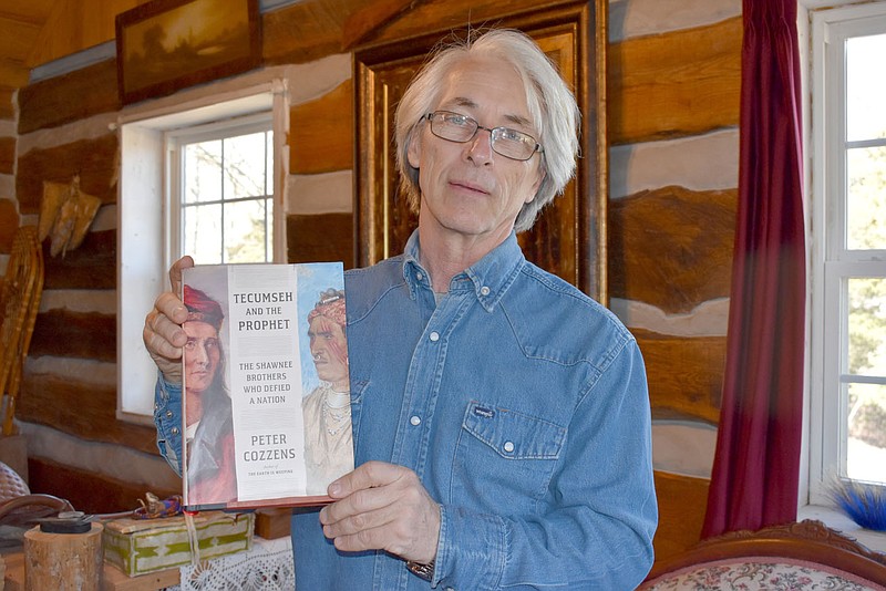 RACHEL DICKERSON/MCDONALD COUNTY PRESS Doug Hall of Pineville is pictured with the Peter Cozzens book "Tecumseh and the Prophet: The Shawnee Brothers Who Defied a Nation," which contains three of his paintings.