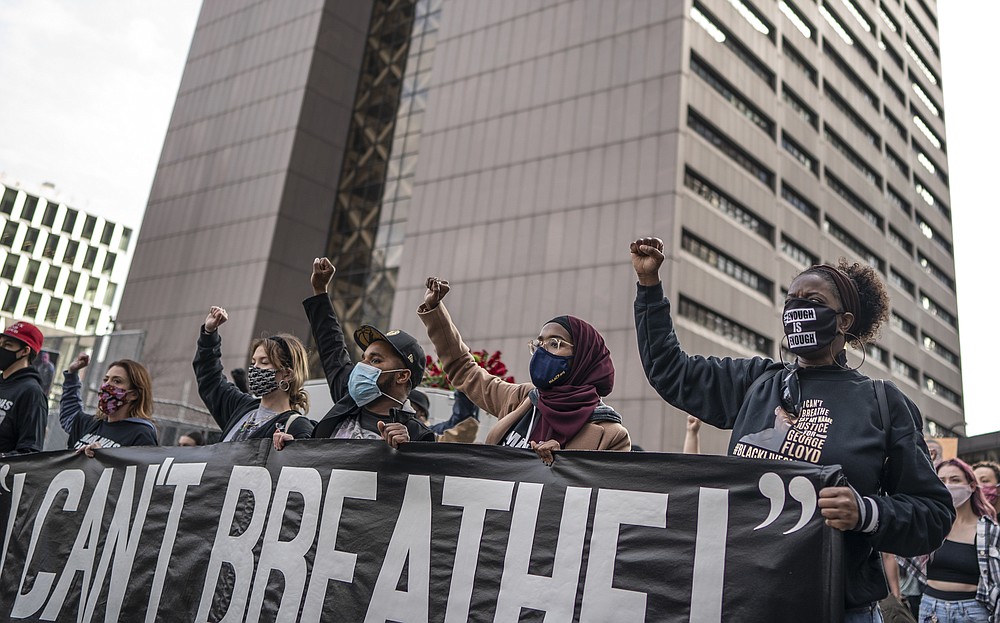 Demonstrators marched past the Hennepin County Government Center one day before jury selection is set to begin in the trial of former Minneapolis officer Derek Chauvin, who is accused of killing George Floyd Sunday, March 7, 2021, in Minneapolis, Minn. (Jerry Holt /Star Tribune via AP)