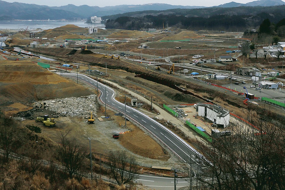 In this file photo dated March 7, 2016, construction work is being carried out in the flat town of Minamisanriku in Miyagi Prefecture in northeastern Japan almost five years after the March 11, 2011 tsunami.  (AP Photo / Eugene Hoshiko, File)