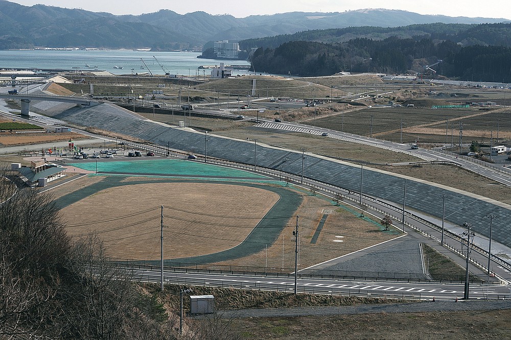 Vehicles drive through the streets of Minamisanriku City in Miyagi Prefecture in northeastern Japan on March 6, 2021, nearly 10 years after the March 11, 2011 tsunami.  (AP Photo / Eugene Hoshiko)