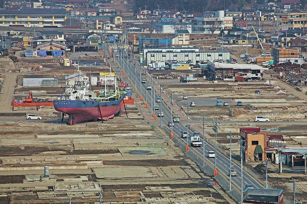 In this file photo dated February 23, 2012, a ship is in a destroyed residential area in Kesennuma, Miyagi Prefecture, northeast Japan, almost a year after an earthquake and tsunami devastated the country's coast.  (AP Photo / David Guttenfelder, file)