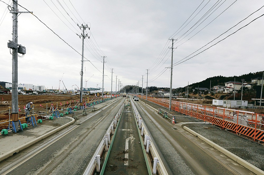 In this file photo dated March 7, 2016, a worker inspects the construction site in Kesennuma, Miyagi Prefecture, northeast Japan.  (AP Photo / Eugene Hoshiko)