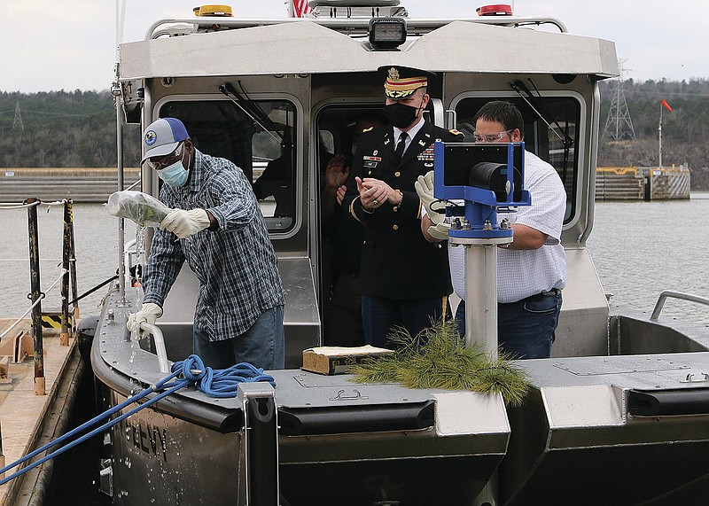 Thomas Peevy (left) of Paris busts a bottle of champagne as Col. Eric Noe (center) and Zane Snider (right) look on during the christening of the U.S. Army Corps of Engineers new survey vessel "Peevy" on Tuesday, March 9, 2021, at the Dardanelle Lock and Dam. The Peevy was named after Thomas Peevy's father, Robert, who was a long-time boat operator for the Corps of Engineers. 
More photos at www.arkansasonline.com/310mkarns/
(Arkansas Democrat-Gazette/Thomas Metthe)