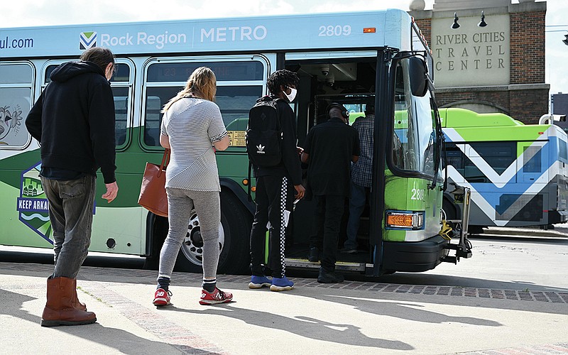 FILE - People wait in line to board their bus at the River Cities Travel Center in Little Rock on Tuesday, March 9, 2021. (Arkansas Democrat-Gazette/Stephen Swofford)