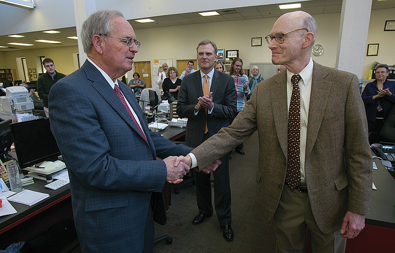 FILE — Publisher Walter Hussman (right) shakes hands with Paul Smith (left) shortly after announcing that Smith would retire as president of WEHCO Newspapers, Inc., early the next year in this Nov. 7, 2013 file photo. Hussman also announced that Nat Lea (center) had been named the new president of WEHCO Media, Inc. (Arkansas Democrat-Gazette/STATON BREIDENTHAL)