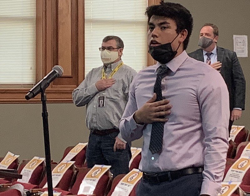 Homero Ruiz, Har-Ber High senior class president, leads the School Board in the Pledge of Allegiance Tuesday at the board's monthly meeting. (NWA Democrat-Gazette/Mary Jordan)