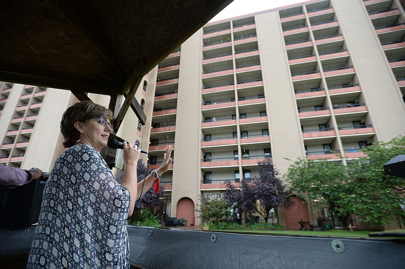 Angela Belford, former executive director of the Fayetteville Housing Authority, speaks Aug. 7 into a microphone as she informs residents at Hillcrest Towers of an expansion project at the facility in downtown Fayetteville. The authority's board voted last week to fire Belford. (File photo/NWA Democrat-Gazette/Andy Shupe)