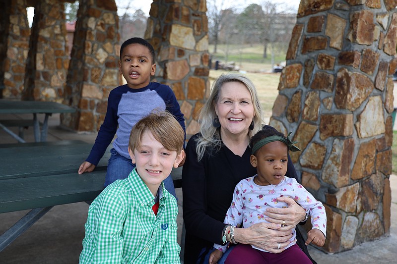 Christie Erwin of Project Zero poses with Qammell, 4 (standing), Isaiah, 9, and Qammell’s sister, Mauria, 2, in Little Rock’s War Memorial Park. The covid-19 pandemic left state agencies and nonprofits dedicated to the cause of fostering and adoption — such as Project Zero, a Little Rock-based agency — scrambling to find new ways to help waiting kids find loving homes. (Special to the Democrat-Gazette/Dwain Hebda)